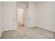 Bedroom features neutral carpeting, multiple closets, and access to the hallway at 3662 Charles Nw St, Conover, NC 28613
