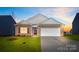 Charming brick home featuring an attached two-car garage, well-maintained lawn, and inviting front entrance at 3662 Charles Nw St, Conover, NC 28613