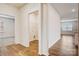 Hallway featuring wood-look floors, a utility closet, and access to the kitchen at 3662 Charles Nw St, Conover, NC 28613