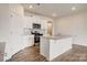 Well-equipped kitchen featuring granite countertops, stainless steel appliances, white cabinets and wood floors at 3662 Charles Nw St, Conover, NC 28613