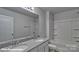 Bright bathroom featuring double vanity with granite countertop and shower-tub combo at 3905 Coleman Dr, Charlotte, NC 28215