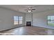 Open-concept living room with a ceiling fan, fireplace, wood floors and natural light at 3905 Coleman Dr, Charlotte, NC 28215
