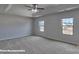 Bright main bedroom with carpet, windows, and a ceiling fan at 3905 Coleman Dr, Charlotte, NC 28215