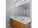 Double sink vanity in a bathroom with a large mirror and modern lighting at 4729 Nijinsky Ct, Charlotte, NC 28216