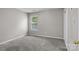 Bedroom with gray carpet, a window, and closet with white doors at 4729 Nijinsky Ct, Charlotte, NC 28216