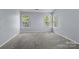 Bright, carpeted bedroom with two large windows providing natural light at 4729 Nijinsky Ct, Charlotte, NC 28216