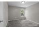 Bedroom with a window and soft gray carpet at 4729 Nijinsky Ct, Charlotte, NC 28216