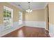 Dining room with hardwood floors, decorative molding, and ample natural light at 4729 Nijinsky Ct, Charlotte, NC 28216