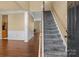 Inviting foyer with hardwood floors, staircase, and elegant white trim at 4729 Nijinsky Ct, Charlotte, NC 28216