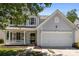 Inviting two-story home with a well-manicured lawn, classic architecture, and an attached two-car garage at 4729 Nijinsky Ct, Charlotte, NC 28216