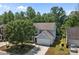 Two-story home with a lush tree in front and an attached two car garage at 4729 Nijinsky Ct, Charlotte, NC 28216