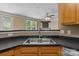 Kitchen sink and modern appliances overlooking the living room at 4729 Nijinsky Ct, Charlotte, NC 28216