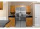 Kitchen with stainless steel refrigerator and wooden cabinets at 4729 Nijinsky Ct, Charlotte, NC 28216