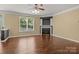 Open living room featuring hardwood floors, fireplace, and ceiling fan at 4729 Nijinsky Ct, Charlotte, NC 28216