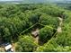 Aerial view of a secluded home surrounded by dense trees and greenery at 503 Overbrook Dr, Albemarle, NC 28001