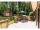Spacious backyard featuring a wooden deck, a shed with double doors, and an umbrella for relaxing outdoors at 503 Overbrook Dr, Albemarle, NC 28001