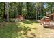 Serene backyard featuring a shed, umbrella, and grassy space, all surrounded by lush trees and greenery for a peaceful retreat at 503 Overbrook Dr, Albemarle, NC 28001