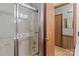 Bathroom shower with glass doors and cream-colored walls next to the open door at 503 Overbrook Dr, Albemarle, NC 28001