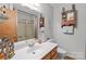 Well-lit bathroom with a vanity, neutral walls, and decorative nautical themed decor at 503 Overbrook Dr, Albemarle, NC 28001