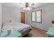 Cozy bedroom with ceiling fan, wood-look floors, and a bright window with blinds at 503 Overbrook Dr, Albemarle, NC 28001
