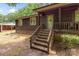 Charming front entrance with stone steps, a covered porch, and warm wood siding, creating an inviting welcome at 503 Overbrook Dr, Albemarle, NC 28001