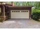 A two-car garage featuring a traditional paneled door, matching the siding of the home's exterior at 503 Overbrook Dr, Albemarle, NC 28001