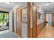 Hallway view with front door, coat closet, and wood-look flooring leading to other areas of the home at 503 Overbrook Dr, Albemarle, NC 28001