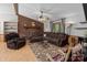 Cozy living room features a brick wall, ceiling fan, plush seating, and natural light at 503 Overbrook Dr, Albemarle, NC 28001