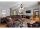 Comfortable living room with wood floors, a large brown couch, and a ceiling fan at 503 Overbrook Dr, Albemarle, NC 28001