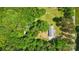 Aerial view highlights a brick home surrounded by lush greenery on a private lot at 6215 Simpson Rd, Charlotte, NC 28216