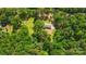 Aerial view shows a brick home surrounded by trees with a sprawling yard at 6215 Simpson Rd, Charlotte, NC 28216