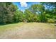 A well sits in the backyard surrounded by lush green trees and a clear blue sky with fluffy white clouds at 6215 Simpson Rd, Charlotte, NC 28216