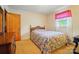Bright bedroom with floral comforter, side table, and natural light at 6215 Simpson Rd, Charlotte, NC 28216