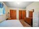 Comfortable bedroom featuring built-in closets and classic wood furniture at 6215 Simpson Rd, Charlotte, NC 28216