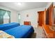 Bedroom with twin beds, window, wood trim, and access to the adjacent bathroom at 6215 Simpson Rd, Charlotte, NC 28216