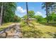 Traditional brick home with lush green lawn and mature trees offering privacy and curb appeal at 6215 Simpson Rd, Charlotte, NC 28216