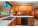 Eat-in kitchen features a window overlooking the living room with wood paneling at 6215 Simpson Rd, Charlotte, NC 28216