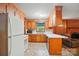 A fully-equipped kitchen features wood cabinetry and a bright window over the sink at 6215 Simpson Rd, Charlotte, NC 28216