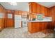 Functional kitchen with white appliances, wood paneling, and ample cabinet space, ready for customization at 6215 Simpson Rd, Charlotte, NC 28216