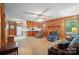 Living room features wood paneling, a brick fireplace, and an open layout leading into the kitchen at 6215 Simpson Rd, Charlotte, NC 28216
