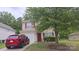 Charming two-story home with a well-maintained lawn and a red Mazda parked in the driveway at 632 Pawley Dr, Charlotte, NC 28214