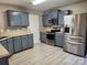 Well lit kitchen featuring stainless steel appliances, blue cabinets, and light countertops at 632 Pawley Dr, Charlotte, NC 28214