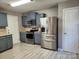 Well lit kitchen featuring stainless steel appliances, blue cabinets, and light countertops at 632 Pawley Dr, Charlotte, NC 28214