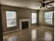 Living room featuring hard wood floors, a fireplace and windows at 632 Pawley Dr, Charlotte, NC 28214