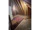 Spacious unfinished attic; exposed rafters with a chair and oriental rug at 67 41St Nw Ave # 3, Hickory, NC 28601