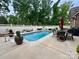 Backyard pool with poolside patio and seating, surrounded by a white fence at 67 41St Nw Ave # 3, Hickory, NC 28601