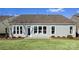 The home's backyard has a grass lawn, small shrubs, and plenty of windows for lots of light at 7017 Treetop Ct, York, SC 29745