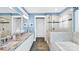Bright bathroom features a double vanity with granite counters, tiled shower and soaking tub at 7017 Treetop Ct, York, SC 29745