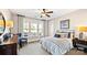 Cozy bedroom with a ceiling fan, a striped bedding set, and large windows for natural light at 7017 Treetop Ct, York, SC 29745