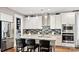 Bright kitchen with stainless appliances, granite countertops, eat-in island, and decorative backsplash at 7017 Treetop Ct, York, SC 29745